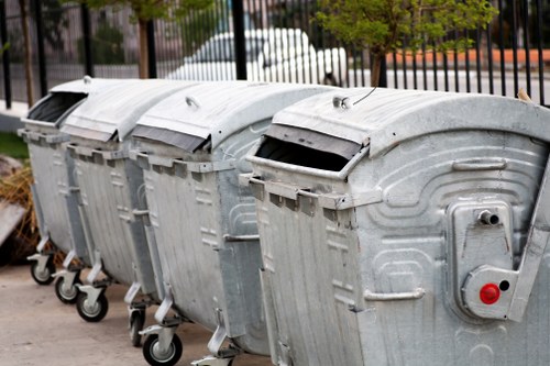 Workers sorting office furniture for recycling in Millhill